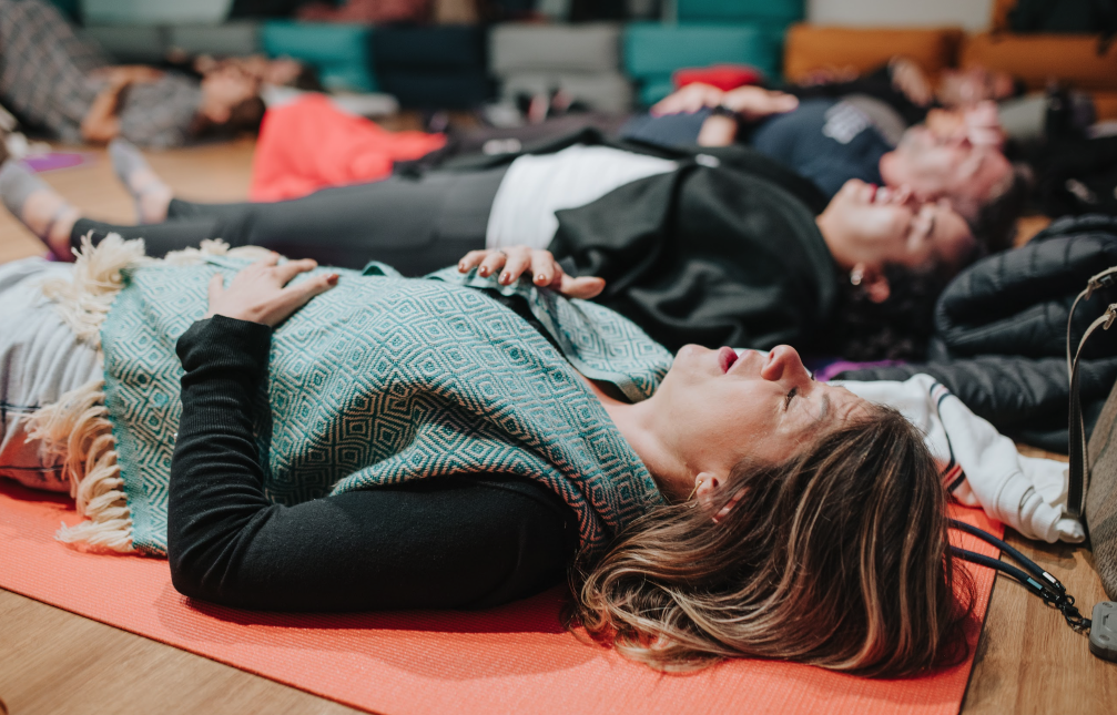 Participants lying on mats in deep rest after breathwork