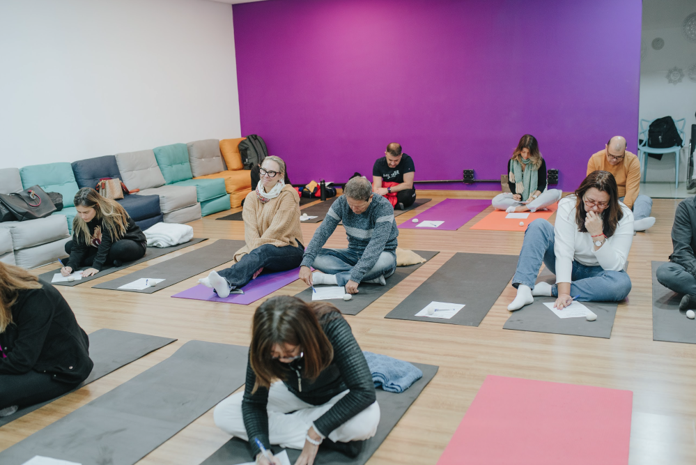Participants writing on mats during a group session