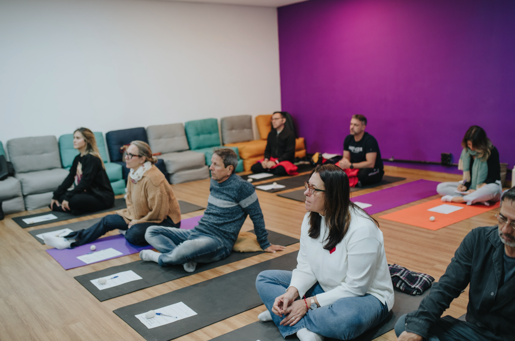 Group seated on mats during a breathwork gathering